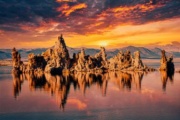 Reflection of tuff rocks in Mono Lake in the Sierra Nevada in California with clouds at sunset by Dieter Walther