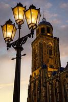 Street lantern in front of the Lebuinus during sunset with clouds in Deventer