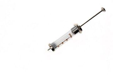 Glass syringe on a white background. Laboratory equipment. by N. Rotteveel