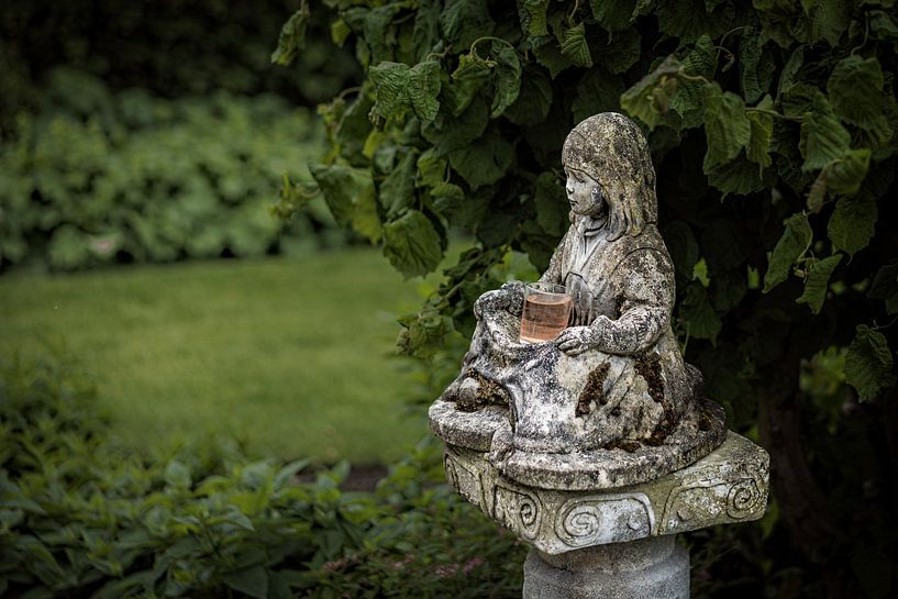 Statue sitting girl in garden by nol ploegmakers