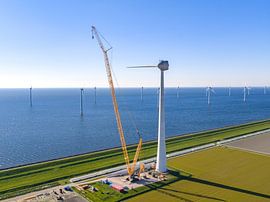 Wind turbine construction with huge cranes at a wind park by Sjoerd van der Wal Photography
