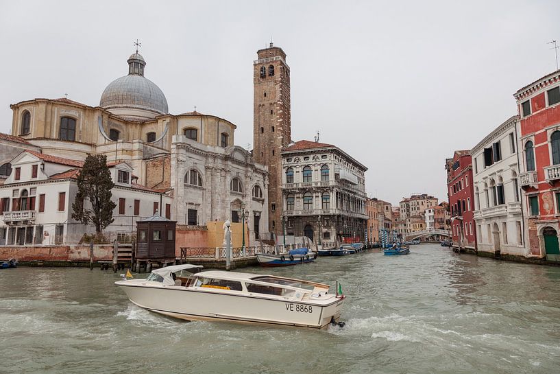 Old buildings, church and white speedboat on canal in old town of Venice, Italy by Joost Adriaanse