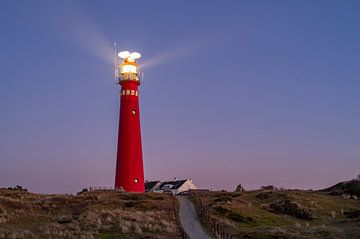Lighthouse at Schiermonnikoog island in the dunes during sunset