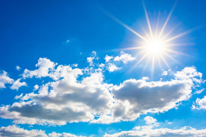 Bright sun on blue sky with clouds by Günter Albers