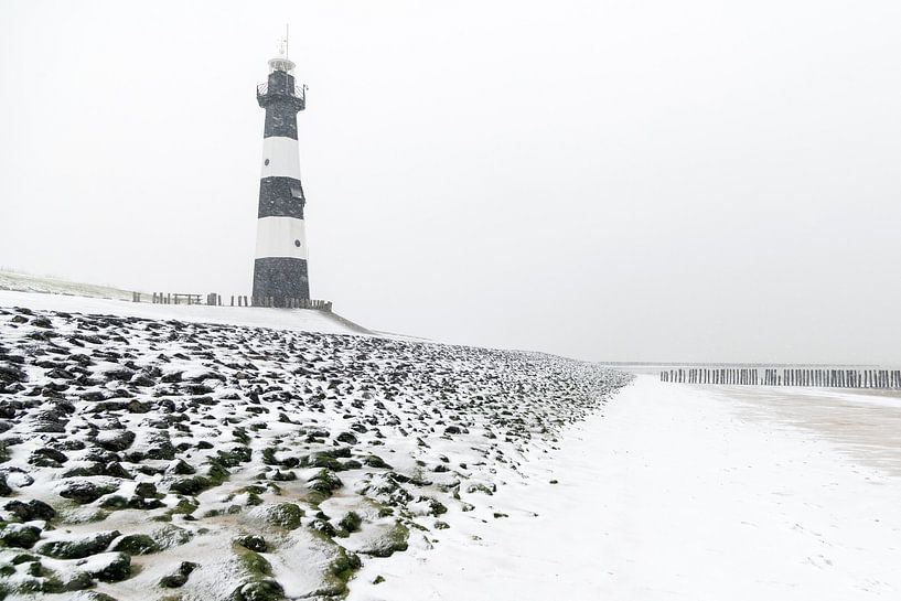 Lighthouse in the snow (2) by Henk Verstraaten