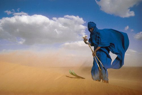Sahara desert. Tuareg on skis.