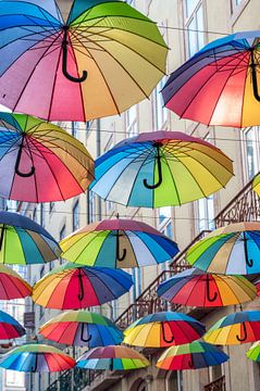 Rainbow umbrellas on Pink street in Lisbon, Portugal by Christa Stroo photography