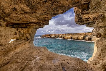 Cave with a view of the rocky coast by Dennis Eckert