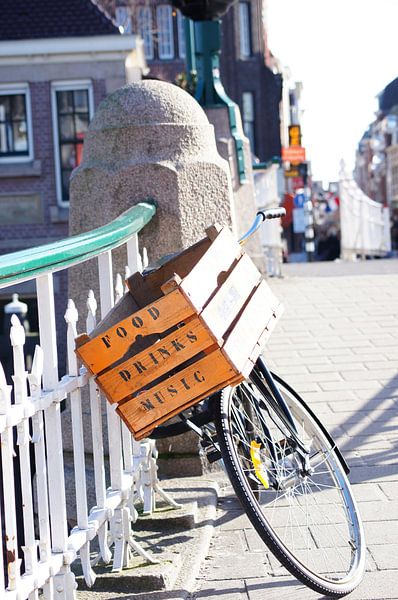 Bicycle with wooden box on bridge by Marion Hesseling