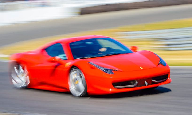 Red Ferrari 458 Italia sports car driving at high speed by Sjoerd van der Wal Photography