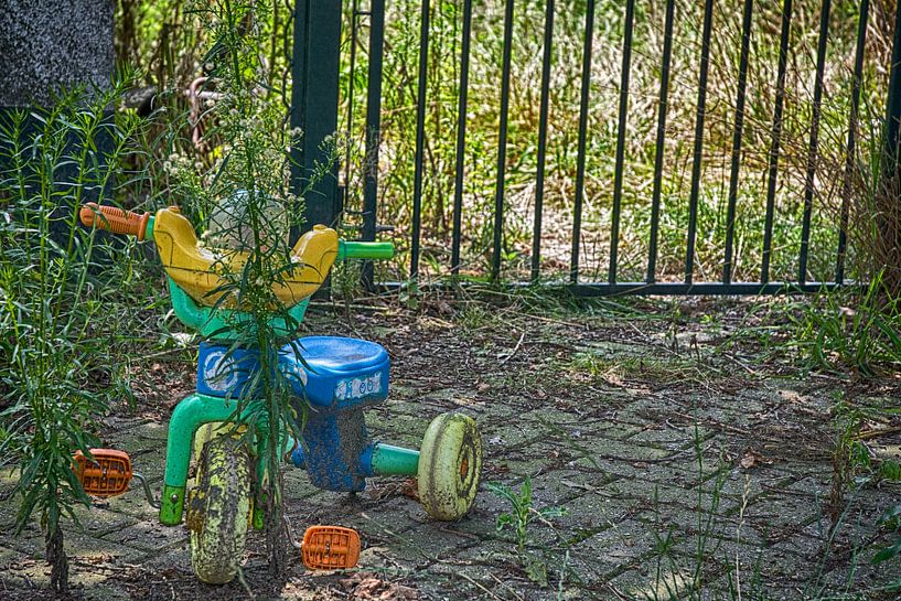 Children's bike at abandoned farm by Anjo Schuite