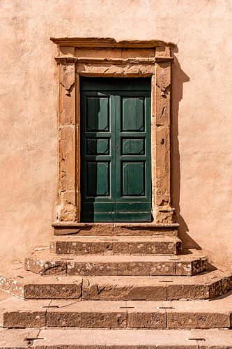 Old blue wooden door with stone steps