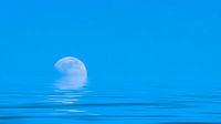Mond über dem blauen weiten Meer mit Reflexionen
