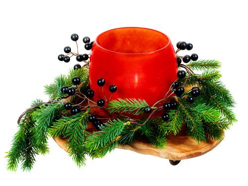 Kerstdecoratie met een kaars in een glas op een witte achtergrond