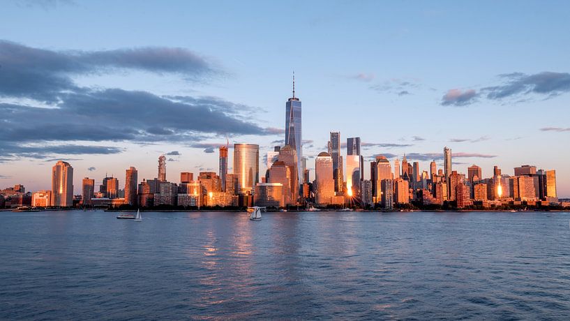 New york city skyline daytime sun clouds blue golden hour by Marieke Feenstra