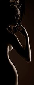 Naked woman with mask against the light by Jörg B. Schubert