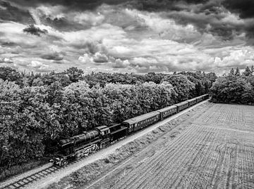 Steam train locomotive driving through the countryside