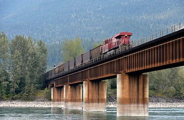 Cargo train crossing over a river bridge in beautiful Canada by Jutta Klassen