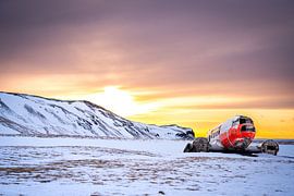 Wrack einer DC-3 in einer verschneiten Landschaft bei Sonnenuntergang, Eyvindarholt, Island von René Wiegmink