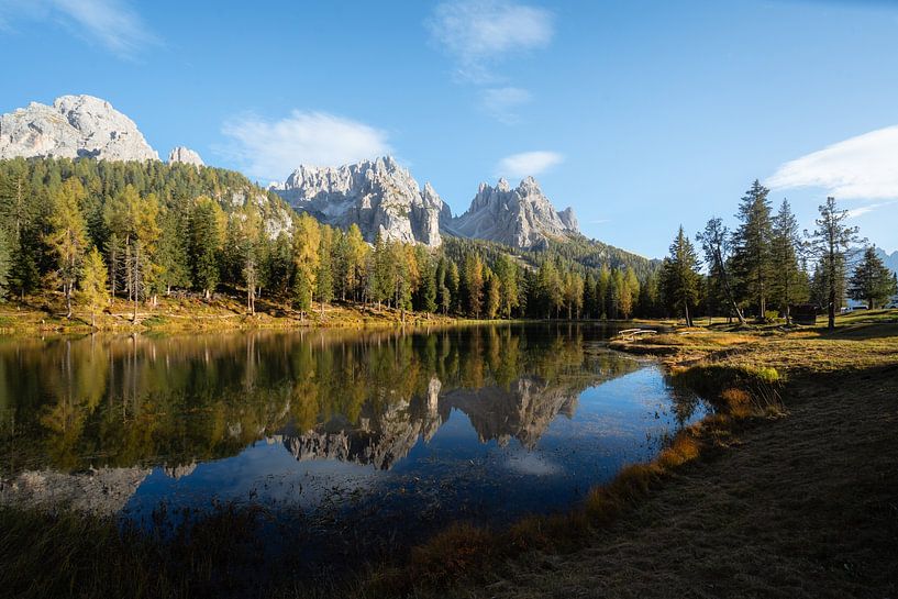 Beautiful reflection of mountains and forests at the edge of a lake by Marit Hilarius