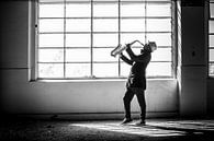 Dark man playing saxophone in an industrial environment by Corine de Ruiter thumbnail