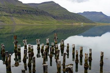 Spiegeling in het water, kust bij Reydarfjördur in IJsland van Henk Alblas
