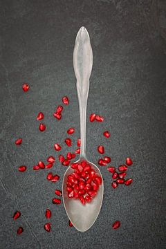 Silver spoon with pomegranate seeds by Photography art by Sacha