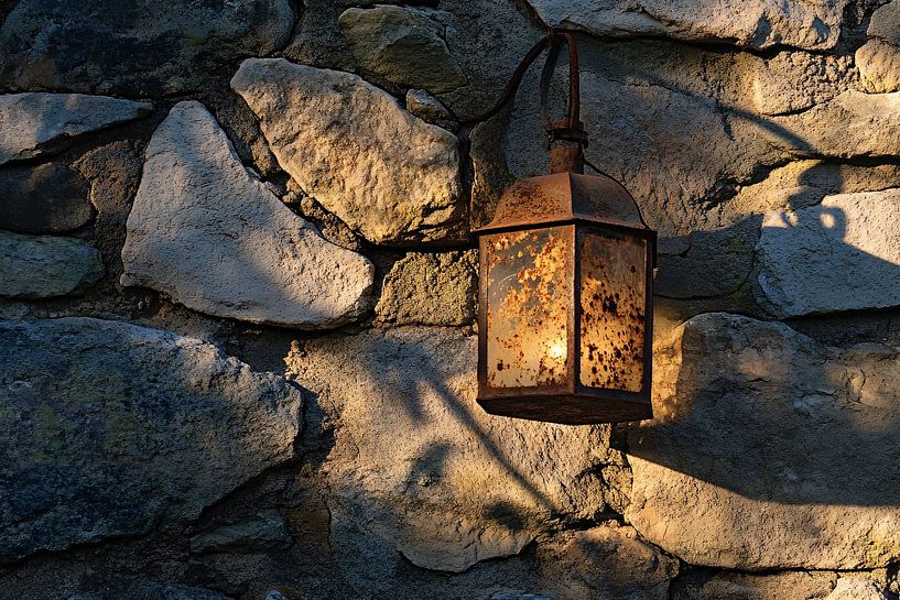 Rusty lantern on stone wall by Imperial Art House