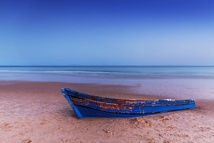 Old wooden boat on the beach by Frank Herrmann