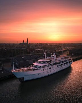 A luxury yacht in Harlingen harbour at sunset by Ewold Kooistra