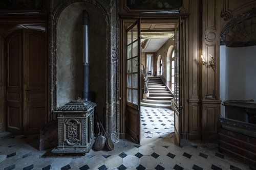 Staircase and stove in dilapidated villa by Inge van den Brande