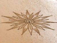 Mandala drawn in the sand by at Praia Maria Luisa in Albufeira in Portugal