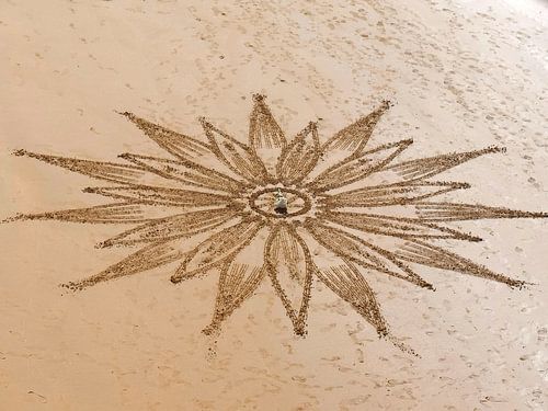 Mandala's getekend in het zand bij Praia Maria Luisa in Albufeira in Portugal