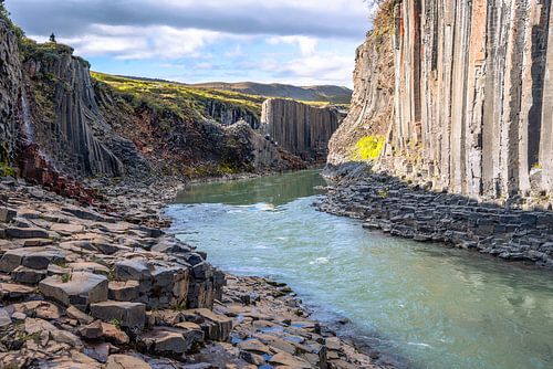 Basalt columns coloured orange by iron oxide, Studlagil Canyon, Egilsstadir, Austurland, Iceland
