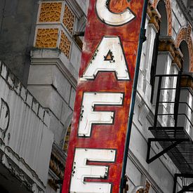 Neglected cafe neon lighting with text on facade by Albert Brunsting