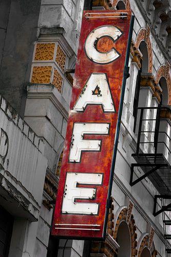 Neglected cafe neon lighting with text on facade