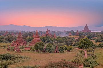 Ancient pagodas in the landscape of Bagan in Myanmar with sunset by Eye on You