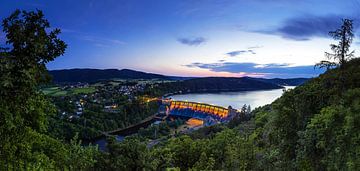 Panorama Edersee dam wall and village with yellow illuminated dam wall at blue hour