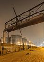 Nacht scène met silo's, viaduct en geplaveide weg van Tony Vingerhoets thumbnail