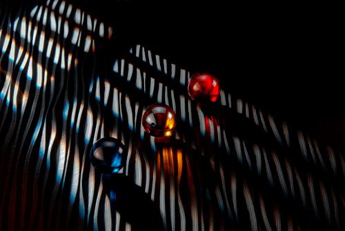 Three marbles with lines of light