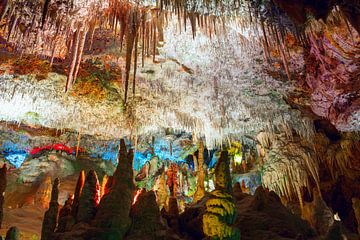 Colorful stalactites and stalagmites in the underground cave by Yevgen Belich