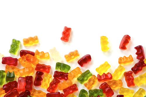 colorful fruit gum candy bears isolated with small shadow on white as a background frame, can be use