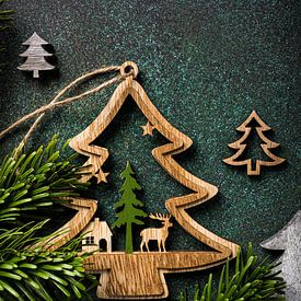 Wooden Christmas trees on green background by Iryna Melnyk