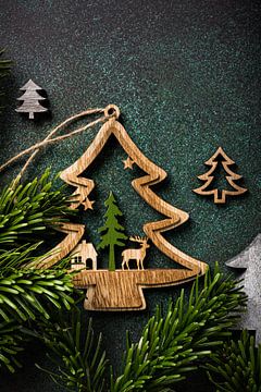 Wooden Christmas trees on green background by Iryna Melnyk