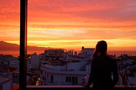 Anonymous woman watches the sunset over Heraklion by Lensw0rld