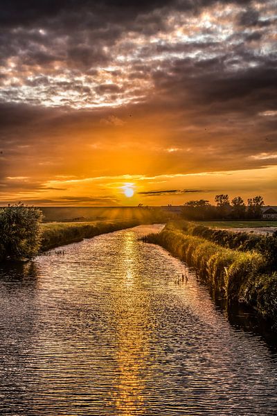 Sunset in the canal of Roptazijl in Friesland by Harrie Muis