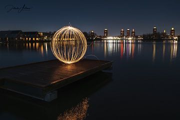 Sphere made of fire sparks on a riser. Background the Ypenburg towers