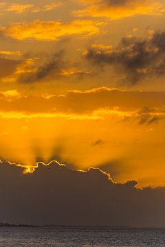 Verenigde Staten, Florida, Oranje zonnestralen van zonsondergang achter wolken aan oceaanwater van adventure-photos