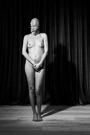 Fetish photography with a beautiful naked woman wearing a bdsm head mask. Photo in black and white #