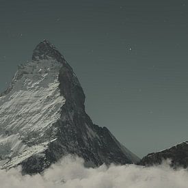 Digital composition of the majestic Matterhorn at night with crescent moon and starry sky by Besart Beluli